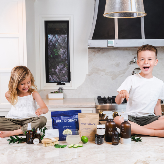 Smiling children around Hugh and Grace products
